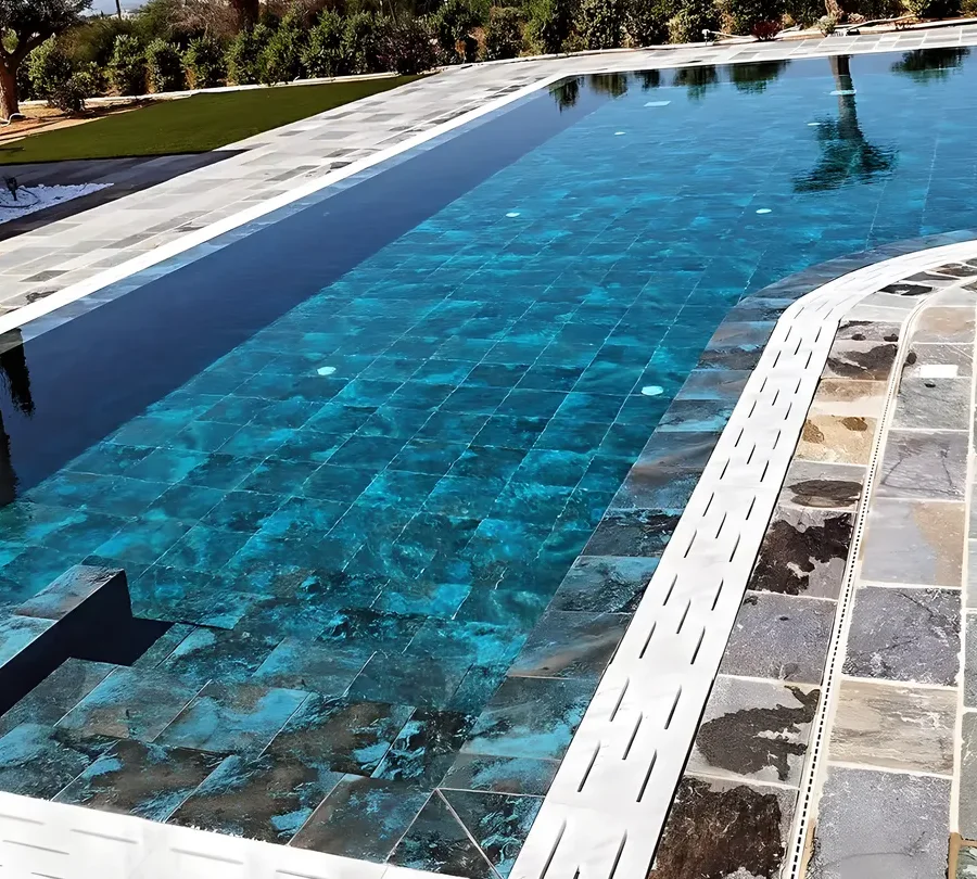 New pool with dark mosaic and slate coping